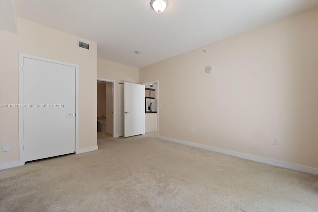 empty room with light colored carpet