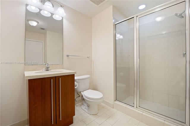 bathroom with walk in shower, vanity, tile patterned flooring, and toilet