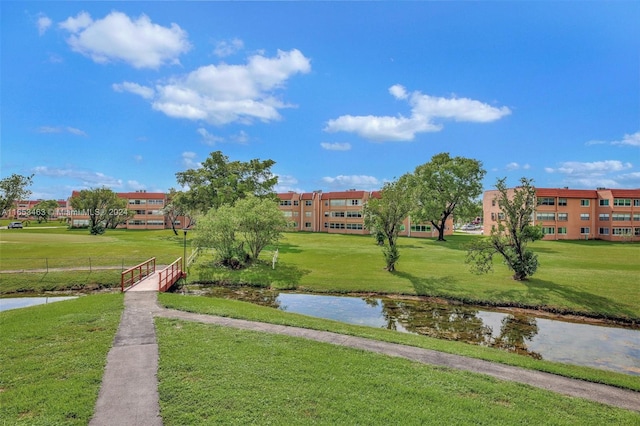 view of community featuring a lawn and a water view