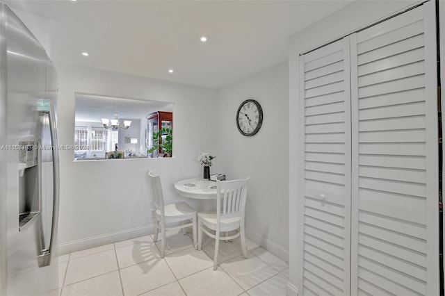 dining space with a notable chandelier and light tile patterned floors