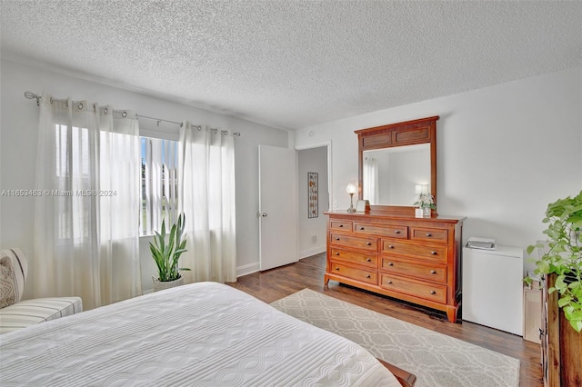 bedroom featuring wood-type flooring and a textured ceiling