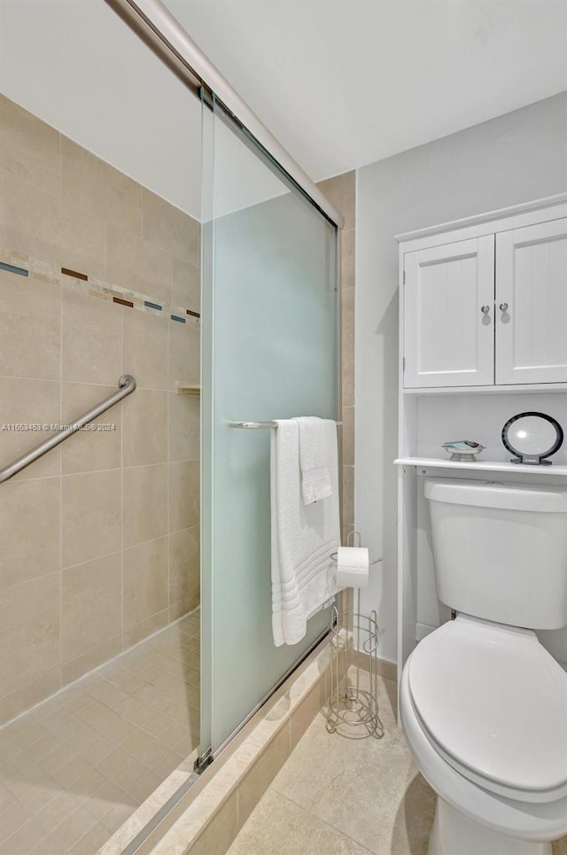 bathroom featuring walk in shower, tile patterned flooring, and toilet