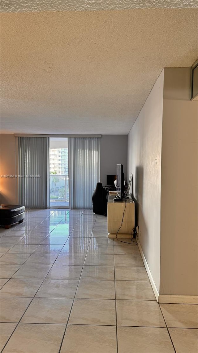 3800 S Ocean Dr Unit 416, Hollywood, FL 33019 - hall with a textured ceiling, light tile patterned flooring, and baseboards