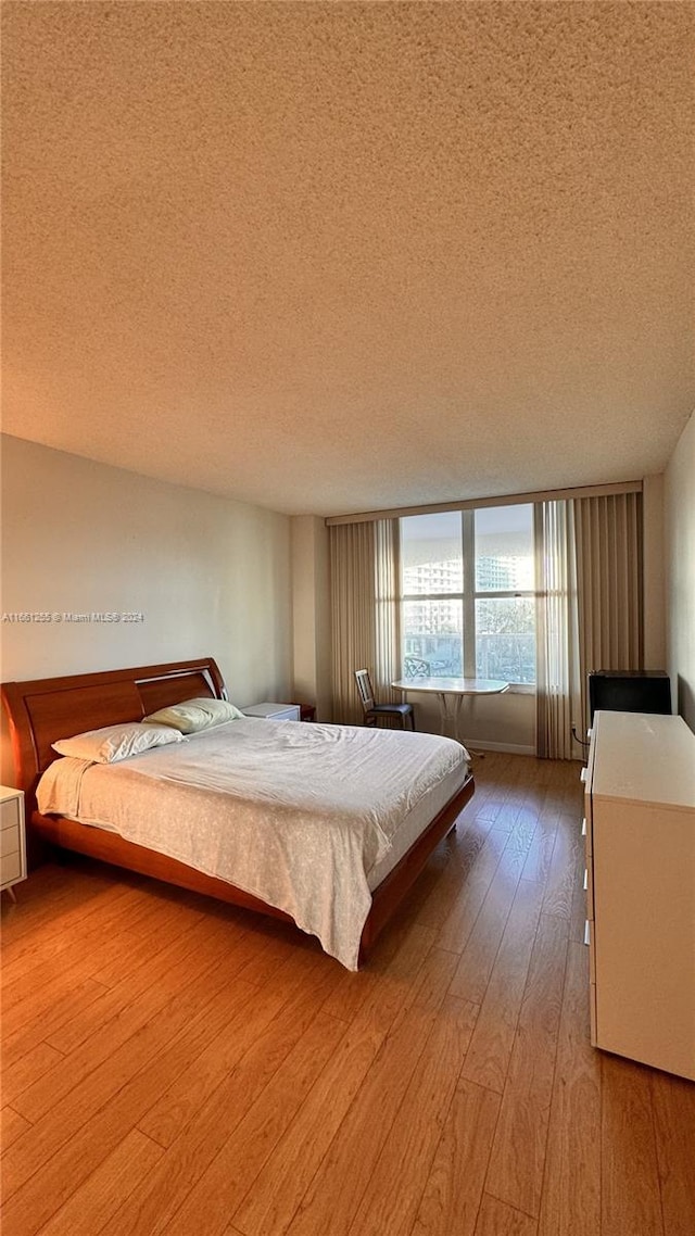 unfurnished bedroom featuring light hardwood / wood-style flooring and a textured ceiling