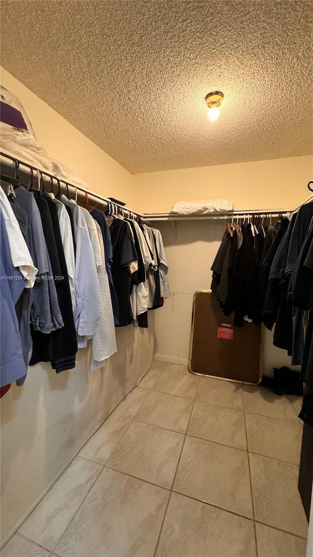 spacious closet featuring light tile patterned floors