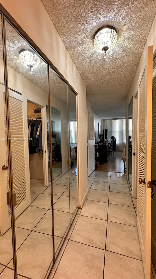 3800 S Ocean Dr Unit 416, Hollywood, FL 33019 - hallway featuring a textured ceiling, french doors, and light tile patterned floors