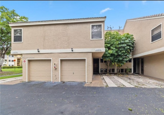 multi unit property featuring a garage