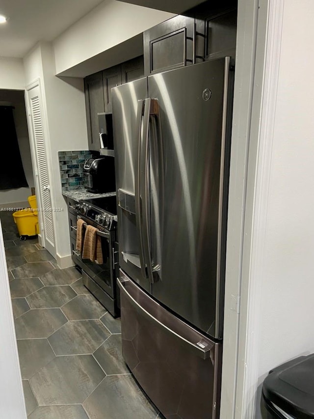 kitchen with dark tile patterned floors and stainless steel appliances