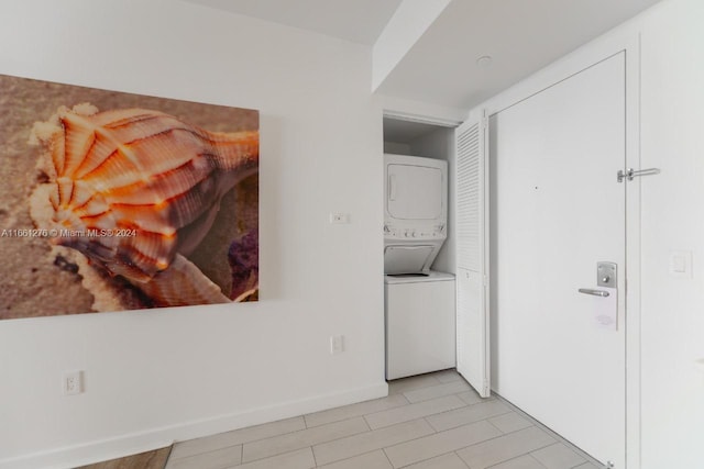 laundry area featuring stacked washer and dryer