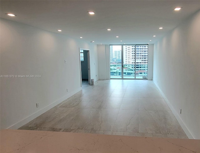 unfurnished room featuring expansive windows