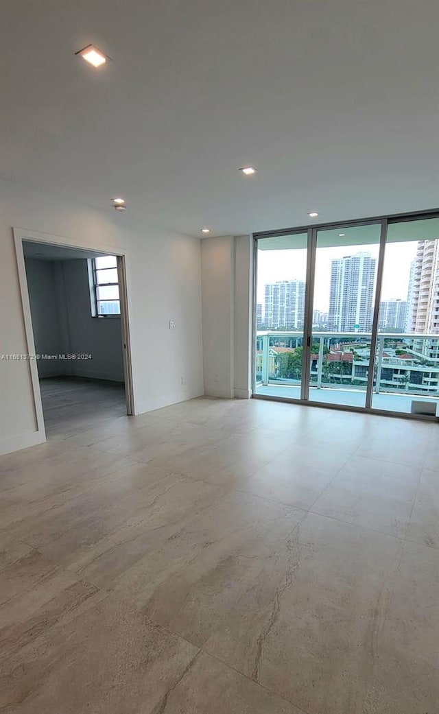 unfurnished room featuring expansive windows