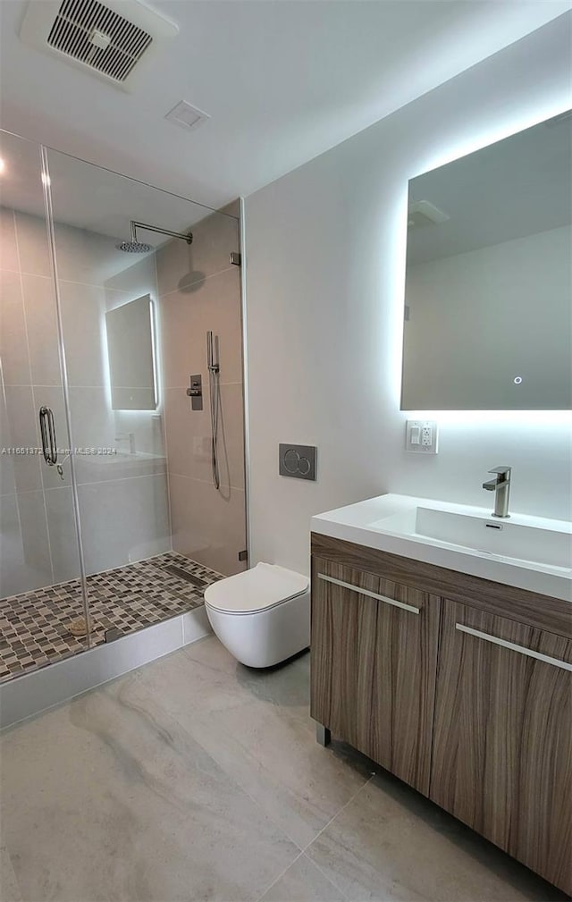 bathroom with tile patterned flooring, vanity, toilet, and walk in shower