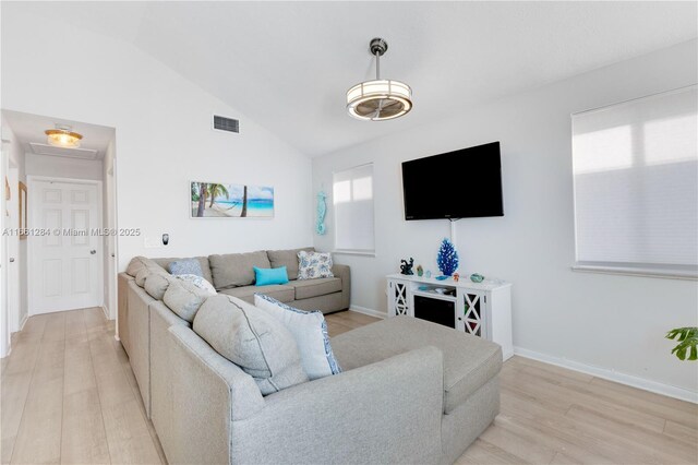 living room with lofted ceiling and light hardwood / wood-style flooring