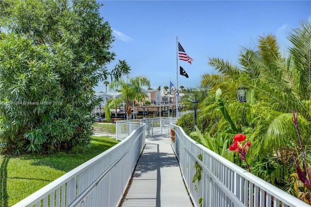 view of community featuring a lawn and a water view