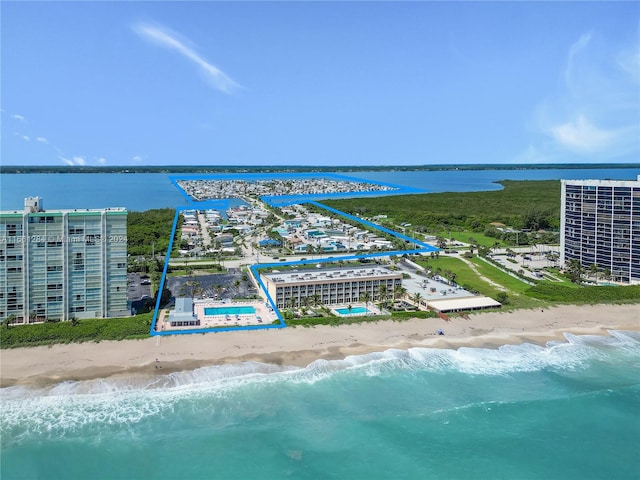 drone / aerial view featuring a water view and a beach view