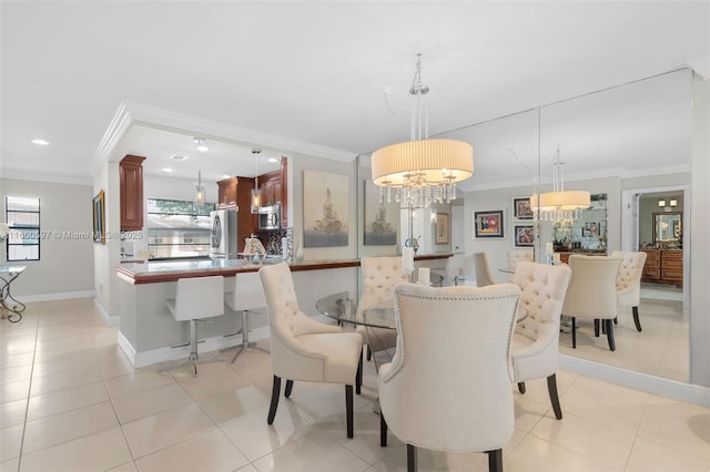 dining room with light tile patterned floors, an inviting chandelier, and crown molding