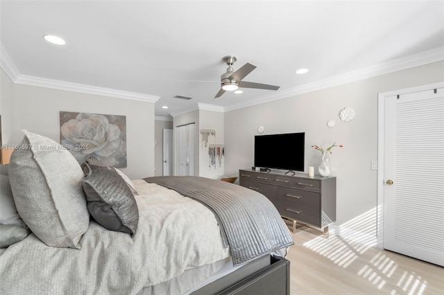 bedroom featuring light wood-type flooring, ceiling fan, and ornamental molding