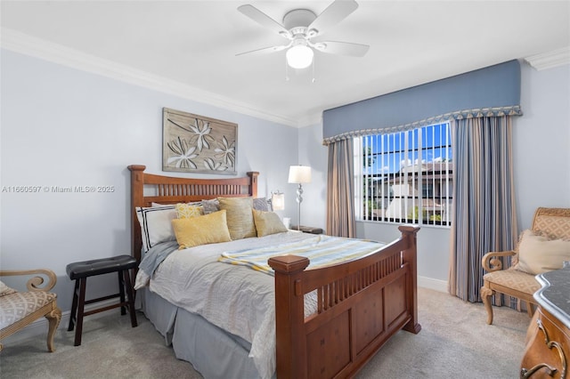 carpeted bedroom featuring ceiling fan and crown molding