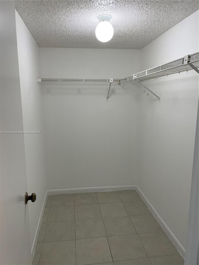 walk in closet featuring tile patterned flooring