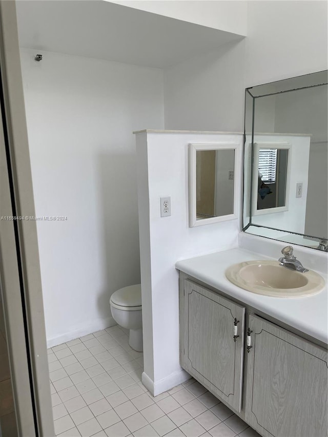 bathroom featuring vanity, toilet, and tile patterned floors