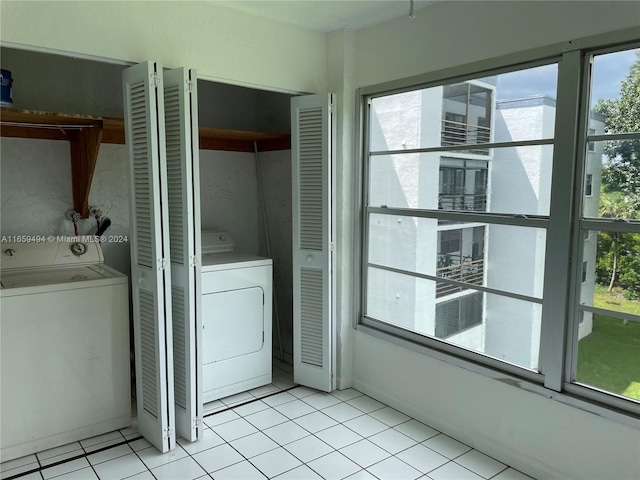 laundry area featuring washer / clothes dryer and light tile patterned floors