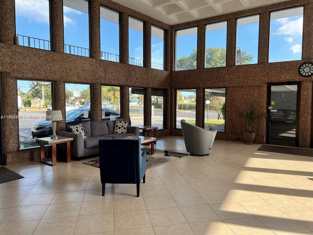 tiled living room featuring a high ceiling