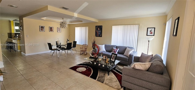 living room with light tile patterned floors, visible vents, a raised ceiling, and ornamental molding