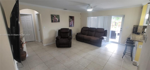 tiled living room with crown molding and ceiling fan