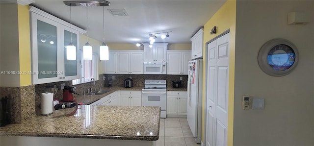 kitchen featuring white cabinets, white appliances, kitchen peninsula, decorative light fixtures, and sink