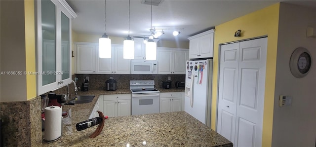 kitchen with white appliances, white cabinetry, sink, and decorative light fixtures