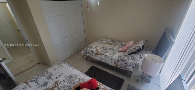 bedroom with a closet and light tile patterned floors