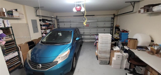 garage with a garage door opener and electric panel