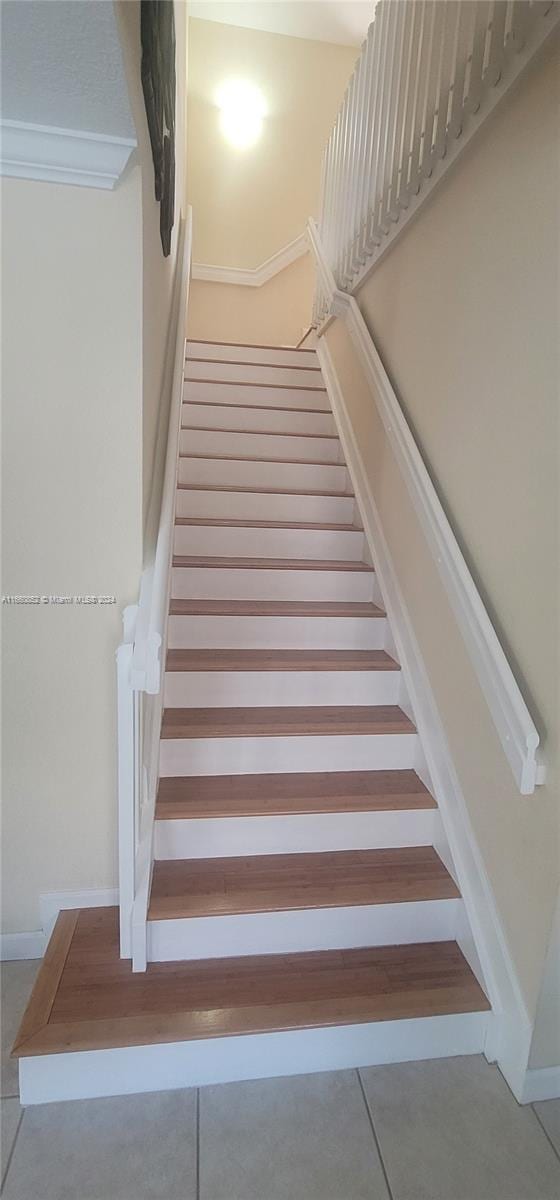 stairs featuring tile patterned floors