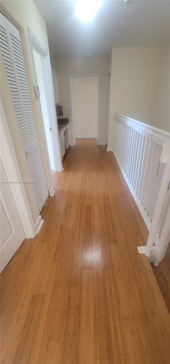 corridor featuring light wood finished floors