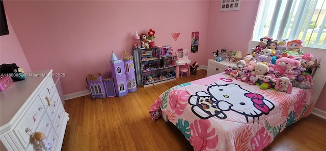 bedroom with baseboards and light wood-style floors