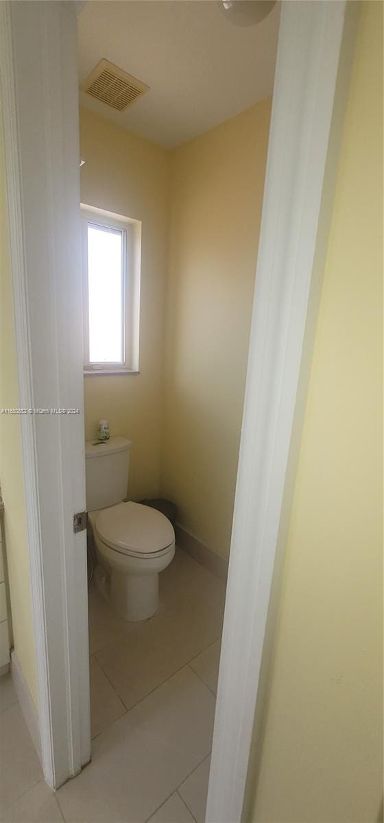 bathroom featuring tile patterned flooring and toilet