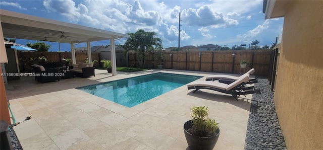 view of swimming pool with ceiling fan and a patio area