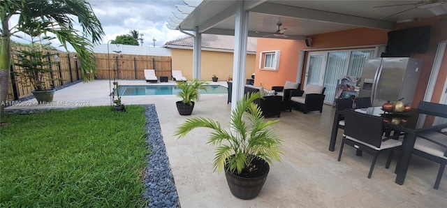 exterior space featuring ceiling fan, a fenced in pool, and a patio area