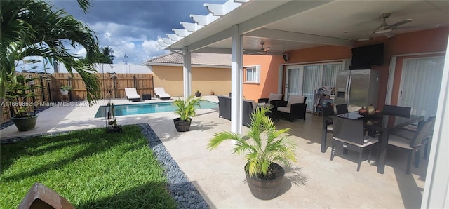 view of patio with ceiling fan and a fenced in pool