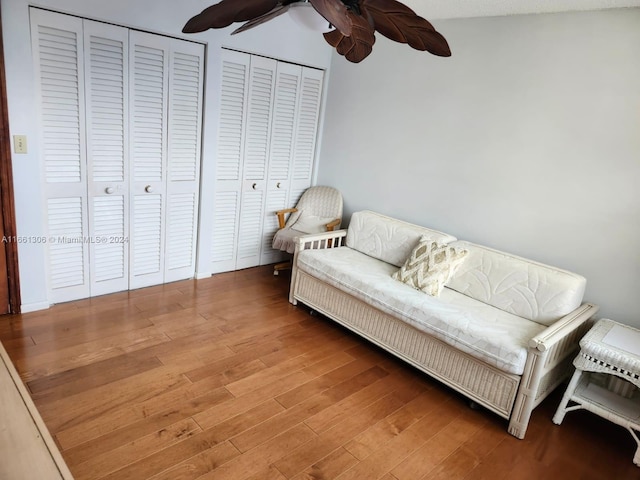 living area featuring ceiling fan, a textured ceiling, and hardwood / wood-style floors