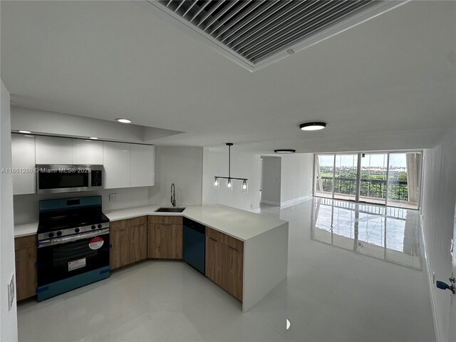 kitchen with stainless steel appliances, white cabinets, hanging light fixtures, and sink