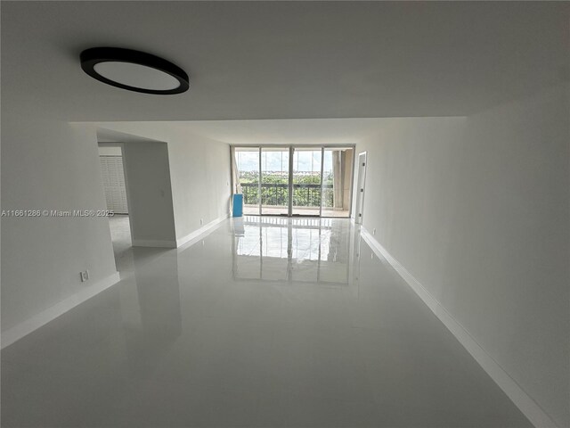 unfurnished room featuring concrete floors