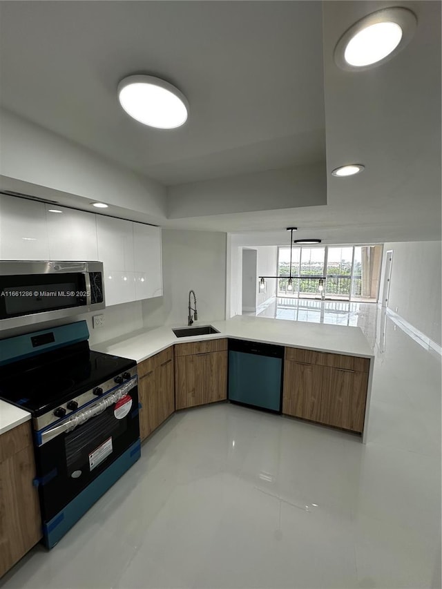 kitchen featuring stainless steel appliances, white cabinets, and sink