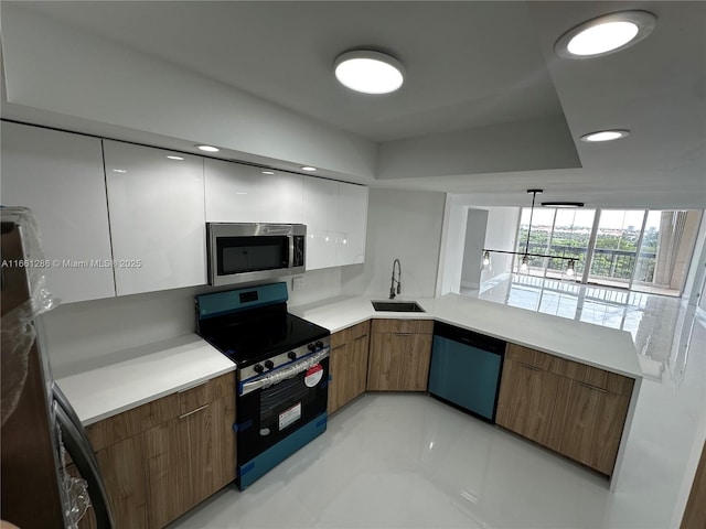 kitchen featuring white cabinets, stainless steel appliances, sink, hanging light fixtures, and light tile patterned flooring