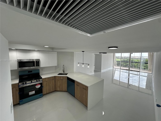 kitchen featuring stainless steel appliances, pendant lighting, white cabinets, and sink