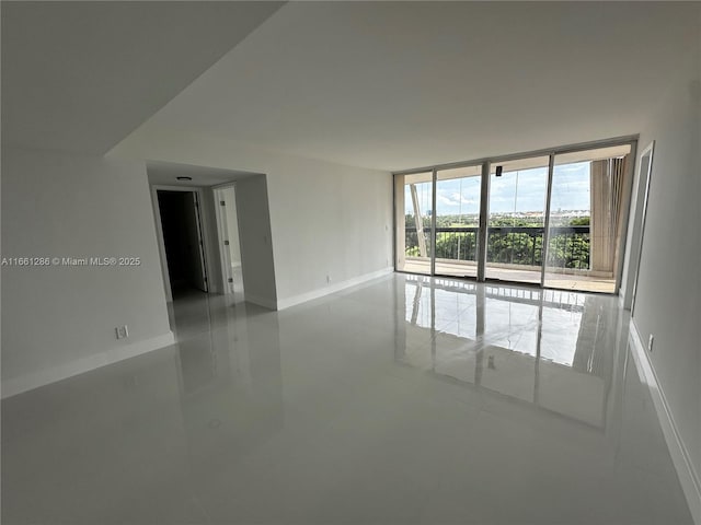 tiled empty room with floor to ceiling windows