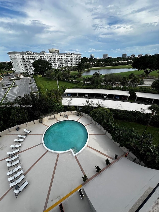 view of swimming pool featuring a water view