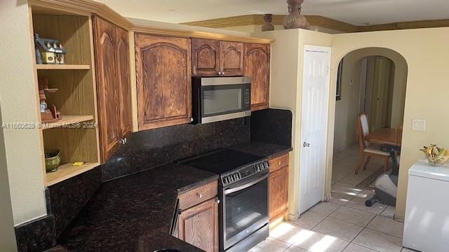 kitchen featuring appliances with stainless steel finishes and light tile patterned flooring