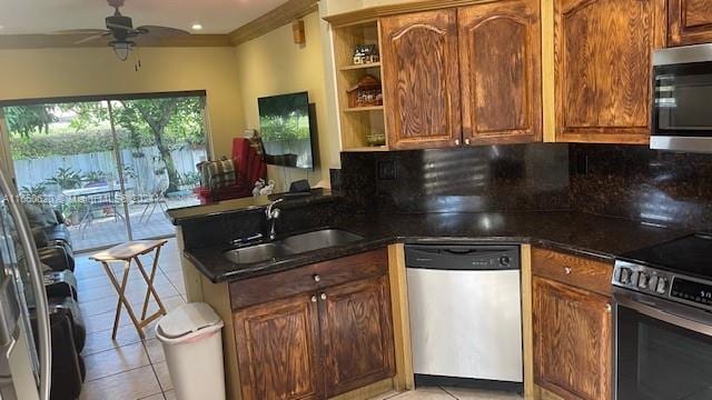 kitchen with ceiling fan, sink, light tile patterned floors, kitchen peninsula, and appliances with stainless steel finishes