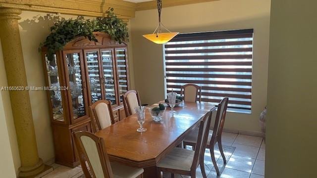 tiled dining area featuring ornate columns and a healthy amount of sunlight